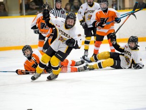 Brayden Vosper (4) of the Mitchell Pee Wees races to corral the loose puck during action from Game 3 of their WOAA Cruickshank final series with Kincardine last Tuesday, March 28. JEFF LOCKHART PHOTO