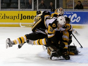 Hamilton Bulldogs’ Matthew Strome falls on Kingston Frontenacs defenceman Stephen Desrocher in front of goalie Jeremy Helvig during Game 5 of an Ontario Hockey League Eastern Conference quarter-final series March 31 at the Rogers K-Rock Centre. (Ian MacAlpine/The Whig-Standard)