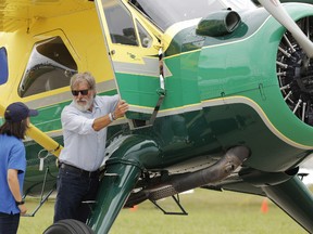 In this July 28, 2016, file photo, Harrison Ford opens the door on his plane for Jodie Gawthorp, of Westchester, Ill., who was selected to fly with Ford, at the Experimental Aircraft Associations AirVenture air show at Wittman Regional Airport in Oshkosh, Wis. Ford told an air traffic controller he was distracted and concerned about turbulence from another aircraft when he mistakenly landed his small plane on a taxiway at a Southern California airport in Feb. 2017. (Joe Sienkiewicz/The Oshkosh Northwestern via AP, File)