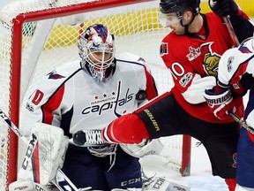 Washington Capitals goalie Braden Holtby (70) stops the puck under his arm as he is screened by Ottawa Senators’ Tom Pyatt (10) in Ottawa on Saturday, January 7, 2017. (THE CANADIAN PRESS/Fred Chartrand)