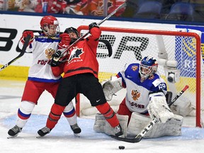 Russian goaltender Maria Sorokina (69) keeps her eye on the puck as Canada’s Sarah Davis (37) and Anna Shibanova (70) get tangled up at the world championship in Plymouth, Mich., on Monday, April 3, 2017. (THE CANADIAN PRESS/Jason Kryk)
