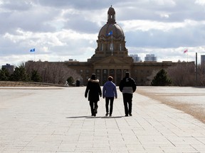 Pedestrians walk through the plaza outside the Federal Building on the Alberta Legislature grounds on Monday April 3, 2017.