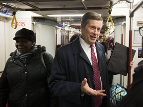 Toronto Mayor John Tory talks to a subway commuter on Monday. (STAN BEHAL, Toronto Sun)