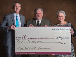 Cambrian College President Bill Best, left, and Cambrian Foundation director Darlene Palmer, right, accept a a $10,000 cheque from Carole and George Fletcher Foundation trustee David Saunders at the Cambrian College Foundation Awards Night on March 22. (Photo supplied)