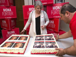 Viane Laflamme-Millette and George Jarawan, right, set up cakes with images of Liberal candidate for Ottawa-Vanier Mona Fortier as supporters wait for the results of a federal byelection in Ottawa on Monday, April 3, 2017. JUSTIN TANG / THE CANADIAN PRESS