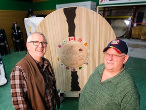 Menno Klaassen (left) and Bill Nestor, along with other members of Edmonton' Woodturners Guild, have created a large commemorative platter in honour of Canada's 150th birthday.