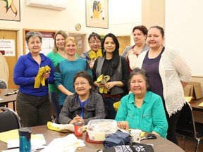 Some of the participants from a 2-day workshop show off their moccasins that they learned to make by Elders Stella McLeod (front left) and Martha Gelinas.