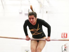 Mackenzie Cortes of Manitoulin Secondary School works the uneven bars at the high school gymnastics championships in Sudbury on Monday. Gino Donato/Sudbury Star