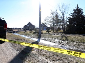Police caution tape surrounds a home on Cooks Cove in East Selkirk, Man., on Tuesday, April 4, 2017 as the RCMP Serious Crime Unit and Forensic Identification officers investigate the scene where two males and one female were discovered dead outside of the residence on Monday, April 3, 2017. Brook Jones/Postmedia Network