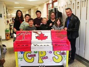 The C.P.S. piano committee poses in front of their creation along with Community Improvement Coordinator Angela Smith and Mayor Jim Ginn. Students in the committee from left to right are Keagan Cook, Jordan Dettweiler, Micah Martin, Savannah Rutledge, Paige Fielder and Amber Reid. Ally Lebreche-Webb is absent from the photo. (Justine Alkema/Clinton News Record)