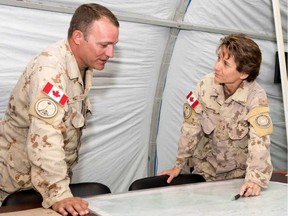 Brig.-Gen. Lise Bourgon confers with Sgt.-Maj. John Short as part of Joint Task Force Iraq in this file photo. Bourgon was honoured from her service at Rideau Hall Tuesday. CANADIAN FORCES IMAGERY / CANADIAN ARMED FORCES IMAGERY