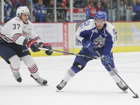 Oshawa Generals Alex DiCarlo and Sudbury Wolves David Levin battle for the puck during OHL playoff action in Sudbury, Ont. on Sunday April 2, 2017. Gino Donato/Sudbury Star/Postmedia Network