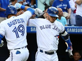 Jose Bautista and Josh Donaldson of the Toronto Blue Jays celebrate a home run against the Baltimore Orioles at the Rogers Centre in Toronto, Ont. on July 29, 2016. (Dave Abel/Toronto Sun/Postmedia Network)