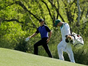 Rory McIlroy talks to his caddie while walking to the 12th hole in Augusta, Ga., yesterday. (AP)