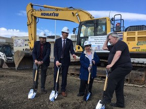 From left: David Shepherd, MLA for Edmonton-Centre, Mayor Don Iveson, and Edmonton People in Need Shelter Society clients Jodi Sharun and Peder Kronborg break ground on a new 97-unit supportive living facility in The Quarters in Edmonton on April 4, 2017.