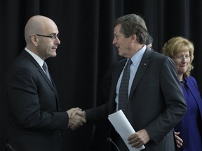 Ontario Minister of Transportation Steven Del Duca (left) and Toronto Mayor John Tory shake hands  during a briefing on the proposed Toronto Pearson Regional Transit Centre. (STAN BEHAL/TORONTO SUN)
