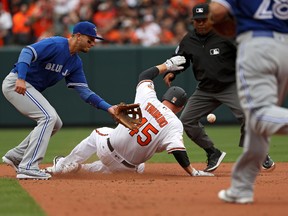 Mark Trumbo of the Baltimore Orioles slides into second base in front of Troy Tulowitzki of the Toronto Blue Jays as he doubles during an Opening Day game at Oriole Park at Camden Yards on April 3, 2017. (Patrick Smith/Getty Images)
