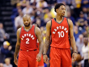 Toronto Raptors guard DeMar DeRozan and forward PJ Tucker return to the bench during an NBA game against the Indiana Pacers in Indianapolis on April 4, 2017. (AP Photo/Michael Conroy)