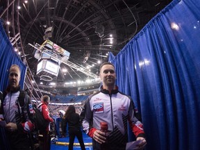 Canada skip Brad Gushue and second, Mark Nichols leave the ice after beating team China following the 10th draw at the Men's World Curling Championships in Edmonton, Tuesday, April 4, 2017. (Jonathan Hayward/The Canadian Press)