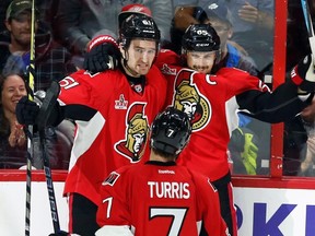 Ottawa Senators' Erik Karlsson celebrates his goal with teammates Mark Stone and Kyle Turris during an NHL game against the Detroit Red Wings in Ottawa on April 4, 2017. (THE CANADIAN PRESS/Fred Chartrand)