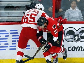 Senators' Clarke MacArthur checks Detroit Red Wings defenceman Danny DeKeyser on Tuesday at the Canadian Tire Centre. (The Canadian Press)