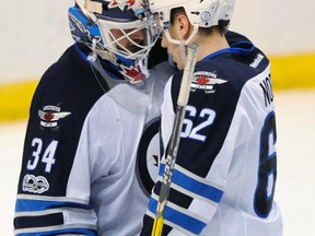 Winnipeg Jets goalie Michael Hutchinson (left) gets kudos from teammate Nelson Nogier during their win in St. Louis. (AP)