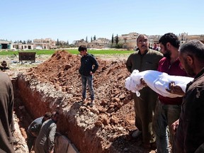 Syrians bury the bodies of victims of a a suspected toxic gas attack in Khan Sheikhun, a nearby rebel-held town in Syrias northwestern Idlib province, on April 5, 2017. FADI AL-HALABI/AFP/Getty Images