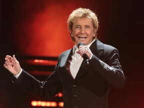 In this March 17, 2016 file photo, Barry Manilow performs in concert during his "One Last Time! Tour 2016" in Hershey, Pa. Manilow tells People magazine that he hid being gay for decades because he thought he would be “disappointing fans if they knew.” The 73-year-old music legend married his longtime manager, Gary Kief, in a 2014 ceremony at their home in Palm Springs, Calif. Manilow tells the magazine’s April 17 issue that keeping their romance out of the media was stressful. (Photo by Owen Sweeney/Invision/AP, File)