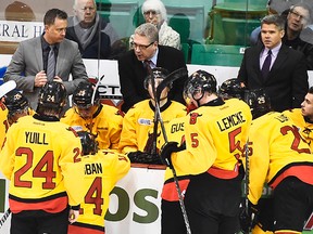 Former Belleville Bulls assistant coaches Jake Grimes (left) and Jason Supryka flank ex-Bulls head coach George Burnett during a 2014-15 OHL game at Yardmen Arena. (Aaron Bell/OHL Images)