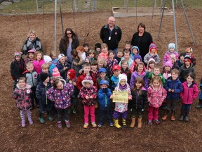 BRUCE BELL/THE INTELLIGENCER
Kindergarten students and their teachers at Picton’s St. Gregory Catholic School join Splash Pad Committee co-chairman Phil St. Jean (middle, back) at the school Wednesday afternoon to tell him about the $329.90 they raised for the project by holding a hat day.