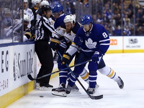 Connor Carrick and Auston Matthews of the Toronto Maple Leafs box out Ryan O'Reilly of the Buffalo Sabres at the Air Canada Centre in Toronto on Jan. 17, 2017. (Dave Abel/Toronto Sun/Postmedia Network)