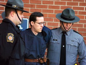 In this Jan. 5, 2015, file photo, Eric Frein is led away by Pennsylvania State Police troopers at the Pike County Courthouse after his preliminary hearing in Milford, Pa. (Butch Comegys/The Times & Tribune via AP, File)