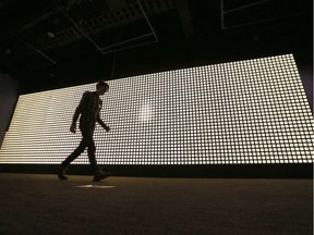 A man walks past 3,598 lights that are part of a Battle of Vimy Ridge exhibit at the Canadian War Museum on Wednesday, April 5, 2017. Each light commemorates a Canadian soldier who died in the battle. TONY CALDWELL / POSTMEDIA NETWORK