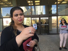 Sarah Hamza holds up a photo of her brother Raad Hamza outside the Edmonton Law Courts on April 4, 2017. Kyle Ashton was convicted of manslaughter in connection to Raad Hamza's death.