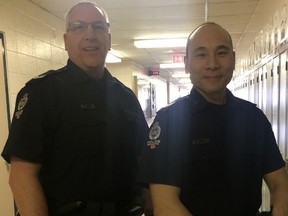 Sgt. Mark Parr, left, and acting Staff Sgt. Em Chan, at H.E. Beriault School Wednesday April 5, 2017, use a new Canadian Centre for Child Protection program which trains school administrators and resource officers to help students remove compromising photos from the Internet. Photo by Jonny Wakefield