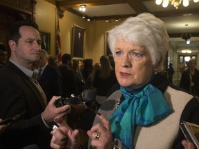Treasury Board President Liz Sandals responds to questions outside of the Ontario Legislature in Toronto Monday. (STAN BEHAL/TORONTO SUN)