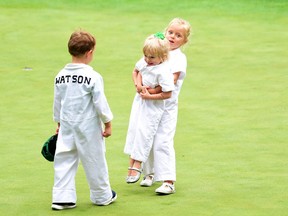 The children of Bubba Watson and Webb Simpson have a little fun during the par 3 contest in Augusta, Ga., yesterday. (Getty Images)