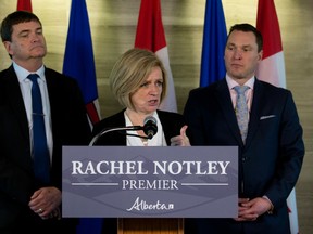 Premier Rachel Notley speaks about recent roundtable discussions she has been having with business leaders in advance of her trip to Washington, D.C., at the Federal Building in Edmonton Friday Feb. 17, 2017. Minister of Agriculture and Forestry Oneil Carlier (left) and Minister of Economic Development and Trade Deron Bilous are pictured behind the Premier. Photo by David Bloom