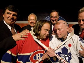 Sacre bleu! It's not easy being a Leafs fan in this mob. Sun columnist Mike Strobel goes blade-to-blade with Dominic Fugere of Le Journal de Montreal in 2008 inside the Hockey Hall of Fame. They're surrounded by former greats Serge Savard, Yvan Cournoyer, Frank Mahovlich and Larry Robinson. (TORONTO SUN/FILES)
