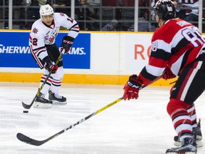Niagara IceDogs forward Akil Thomas tries to get the puck past Kevin Bahl of the Ottawa 67's on Jan. 28, 2017 at TD Place Arena in Ottawa. (Ashley Fraser/Postmedia)