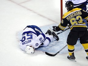 Tampa Bay Lightning defenceman Jake Dotchin lays on ice after an altercation with Boston Bruins left wing Brad Marchand during an NHL game on April 4, 2017. (AP Photo/Charles Krupa)