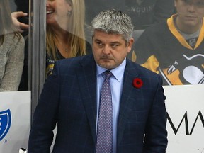 Edmonton Oilers coach Todd McLellan stands behind Connor McDavid (97) during the first period of the team's NHL hockey game against the Pittsburgh Penguins in Pittsburgh, Tuesday, Nov. 8, 2016. The Penguins won 4-3.