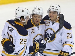 Buffalo Sabres right winger Kyle Okposo, centre, celebrates a goal during an NHL game in Winnipeg on Oct. 30, 2016. (Brian Donogh/Winnipeg Sun/Postmedia Network)
