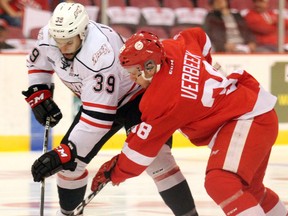 Soo Greyhounds centre Hayden Verbeek and Owen Sound Attack centre Cordell James fight for puck possession during first-period OHL playoff action Wednesday evening at Essar Centre. JEFFREY OUGLER/SAULT STAR