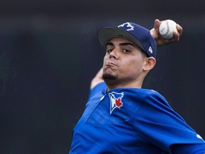 Jays closer Roberto Osuna was throwing the ball Wednesday under watchful supervision. (The Canadian Press)