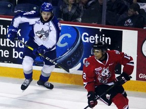 Niagara IceDogs forward Akil Thomas defended by the Sudbury Wolves in Ontario Hockey League action on Saturday, March 18, 2017 in St. Catharines, Ont. Bernd Franke/Welland Tribune/Postmedia Network