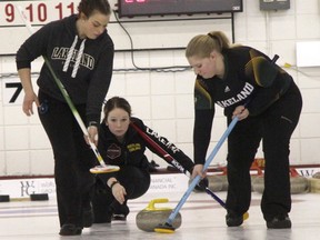 Lakeland College Rustlers second Kaylee Duncan has her shot swept by lead Alyssa Antoneshyn and this Desiree Bealieu against the Red Deer College Queens during Day 3 action of the Canadian Collegiate Athletic Association Curling Championships at the Rose City Curling Club in Camrose, Alta. on Friday March 24, 2017. Josh Aldrich/Camrose Canadian/Postmedia Network