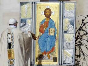 Pope Francis sprinkles incense in front of an icon of Jesus during a celebration of Easter mass at the Vatican in St. Peter's Square on March 27, 2016. (Gregorio Borgia/The Associated Press)