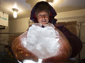 Professor Martin Sharp holds an ice core sample while he poses for a photo in the University of Alberta's glacier chemistry facility freezer, in Edmonton Alta. on Wednesday Feb. 24, 2016.