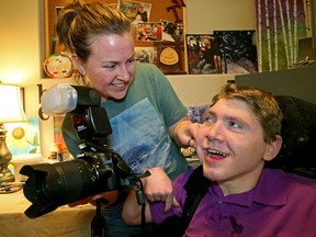 In 2016, Nathan Devlin smiles as his assistant Renee Laporte holds his camera in his art studio inside his house. Three years ago, Cam Tait wrote his first Tait on Eight column on the two.